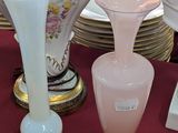 de nombreux vases et assiettes sur la table recouverte d'une nappe rouge