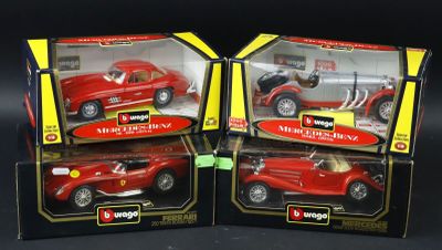 two red toy cars are in a box on a black surface