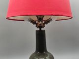 an image of a green lamp with a red shade on it