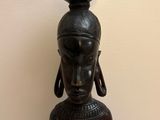 an image of a statue of a woman with a pot on her head