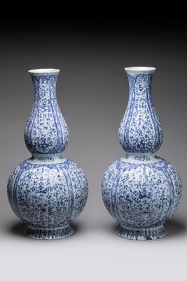 pair of blue and white vases with floral designs on them