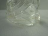 a clear glass jar with a lid on a white surface