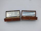 two wooden boxes with mirrors on them on a white surface