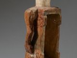 an image of a wooden statue of a man holding a chair