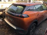a burnt orange car parked on the side of the road