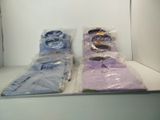 two pairs of shirts wrapped in plastic bags on a shelf