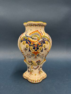 a vase that is sitting on a blue surface