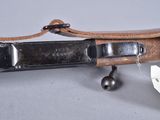 a knife that is laying on top of a leather case