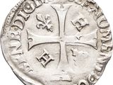 a close up of a coin with a cross on it