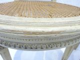 a white chair with a wicker seat on a white background
