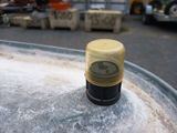 a close up of a yellow cap on top of a metal container
