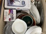 une boîte en carton remplie d'assiettes et de bols de toutes sortes