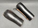 two leather sheaths that are sitting on a table