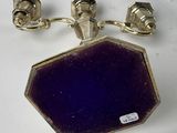 pair of silver and purple glass cufflinks on a white surface
