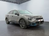 a grey car is parked in a white room with a black floor