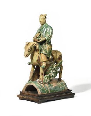 statue of a man sitting on a horse with a dog on the back