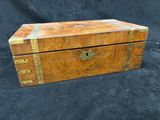 an old wooden box with a flower design on the lid