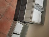 two open refrigerators sitting on the floor next to a person