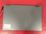 a close up of a laptop computer on a red surface