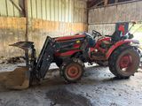 a tractor that is parked inside of a barn