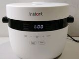 an instant rice cooker sitting on a counter top