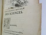 an open book with a drawing of a man in a boat
