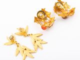two pairs of gold earrings with leaves and pearls on them