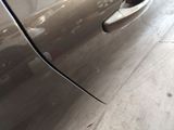 a close up of a car door handle with a hole in it