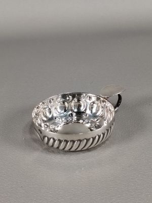 a close up of a silver ring on a white surface