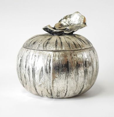 a silver container with a bird on top of it