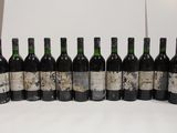 bottles of wine are lined up in a row on a table