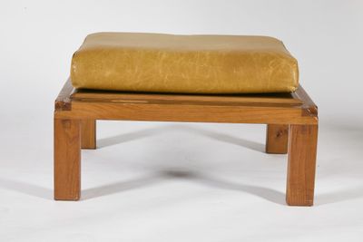 a wooden bench with a yellow cushion on it