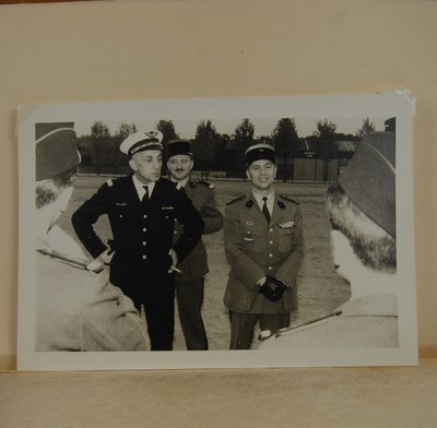 two men in military uniforms standing next to each other