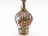 a vase with a floral design on it on a white surface