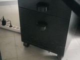 a black desk with a computer on top of it