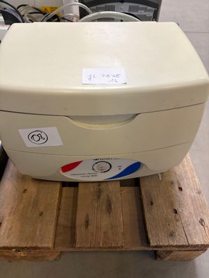 a printer sitting on top of a pallet in a warehouse