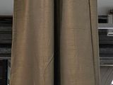 a curtain hanging on a rail in front of a window