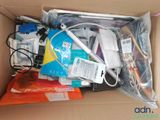 a cardboard box filled with electronic devices and other items