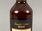 a close up of a bottle of whisky sitting on a table