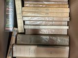 a box full of books sitting on top of each other