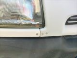 a close up of a car ' s headlight on a street