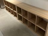 a wooden shelf with several shelves on it in a room