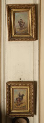 three paintings hanging on the wall of a room