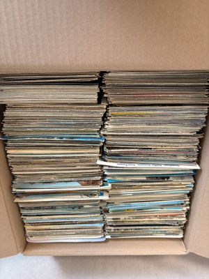 an open cardboard box filled with lots of cds and cds