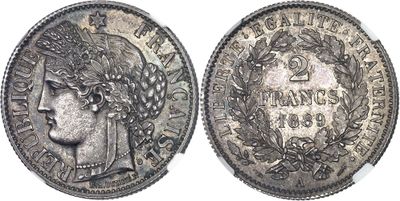 a silver coin with a woman ' s head and laurels on it