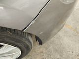 a close up of a car that has a denting on the side of it