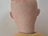 a small doll with a star on it ' s head