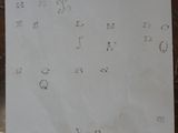 a piece of paper on a table with a clock on it