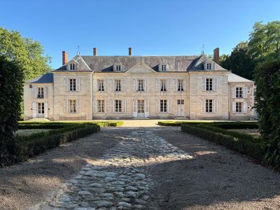 an image of a large house with a stone path in front of it