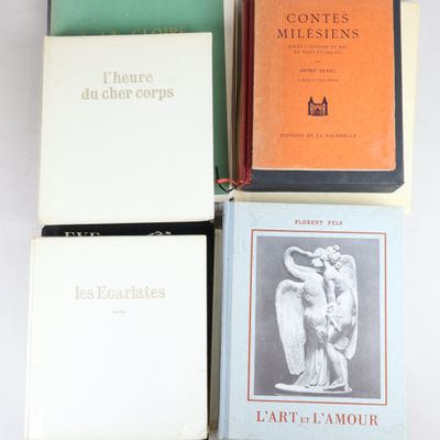 four books are stacked on top of each other on a table